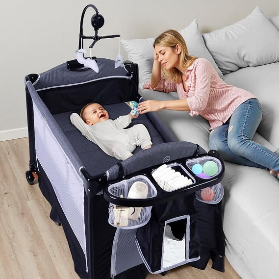 4 in 1 Pack and Play, Portable Playard Baby Bassinet Bedside Crib | Foldable Travel Baby Nursery, Playpen for Babies and Toddlers with Changing Table, Storage Basket, Music Box, Breathable Mesh